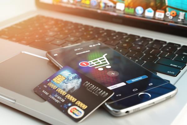 platobná karta a mobil položené na notebooku